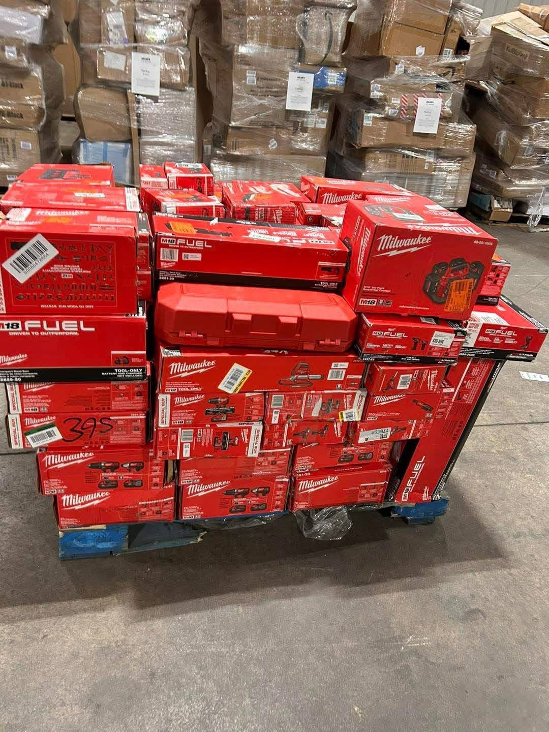 Forklift moving palletized boxes toward a freight trailer