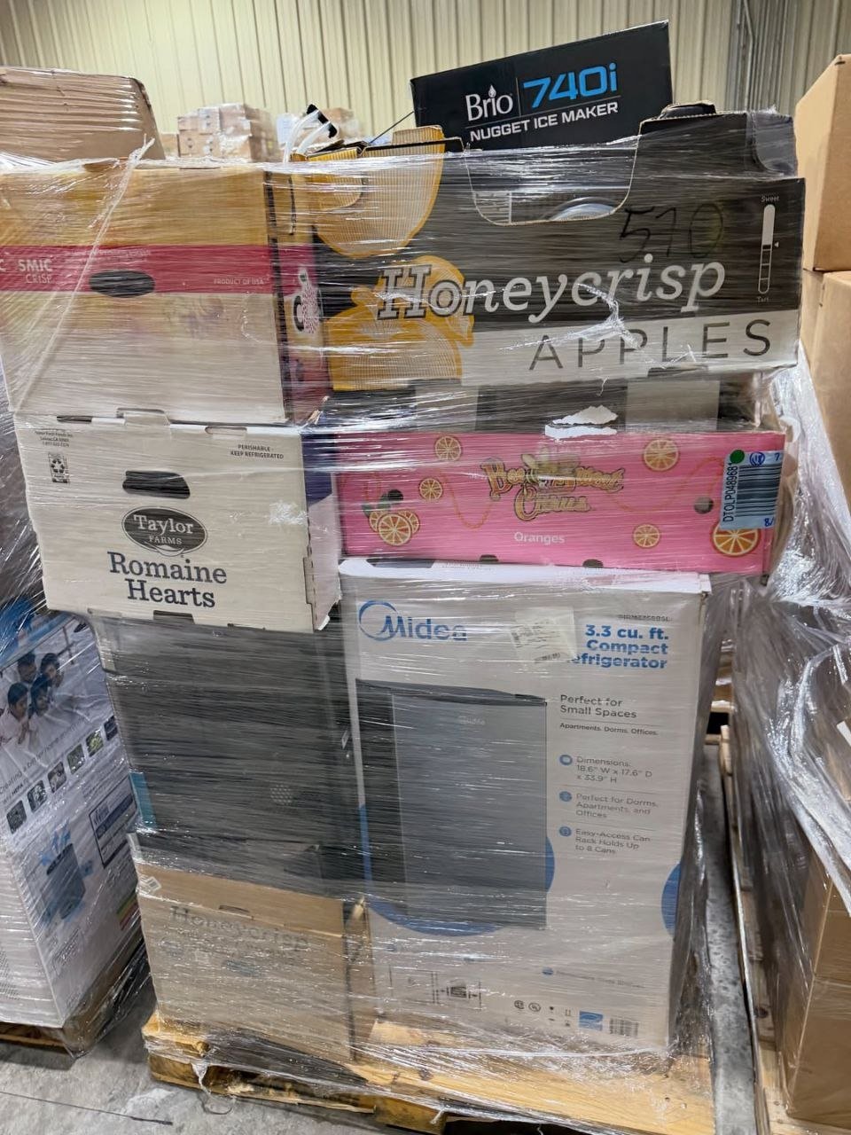 Wrapped mixed merchandise pallet showing boxed appliances and household goods