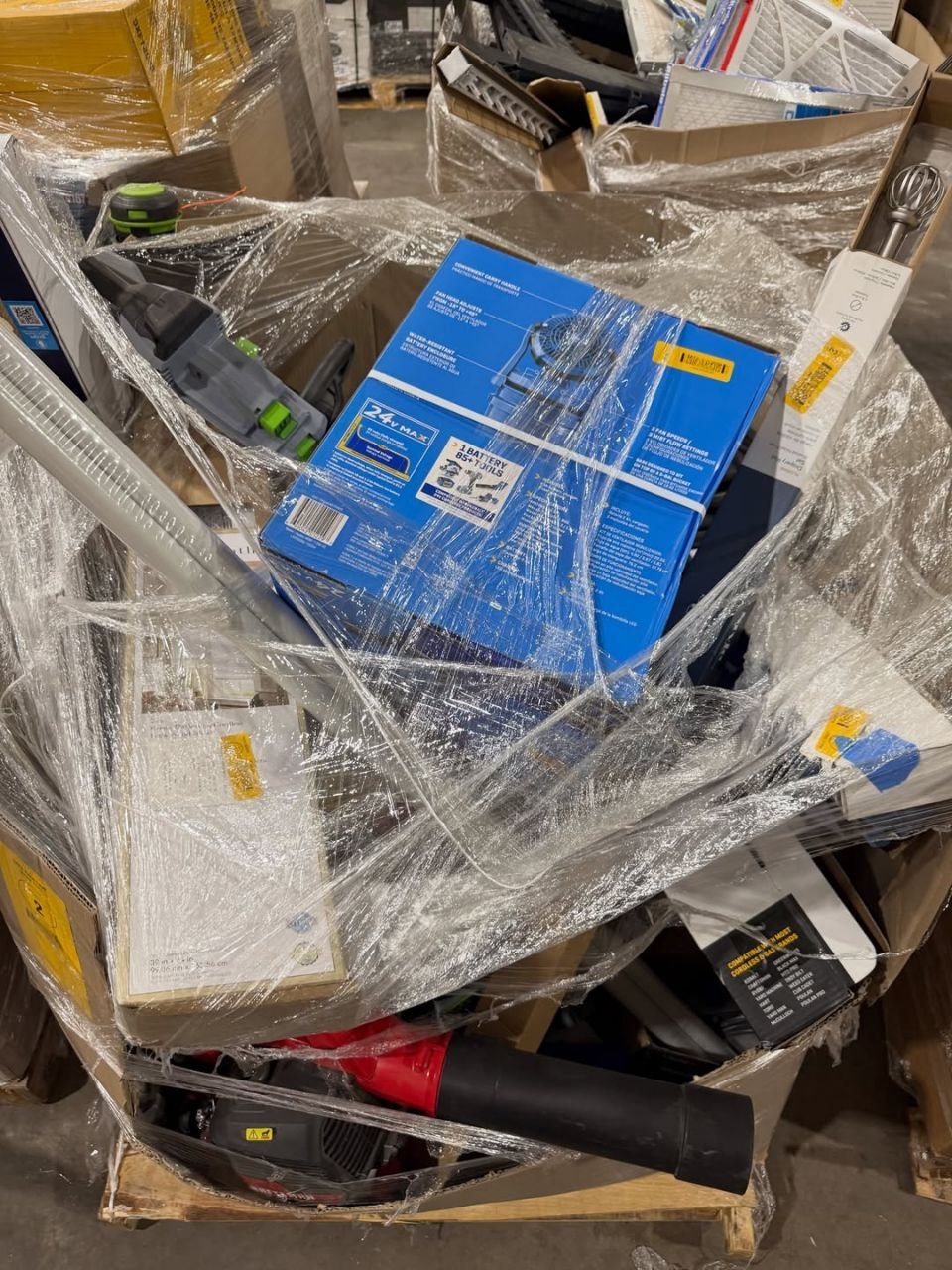 Assorted boxed goods and tools inside wrapped wholesale pallet