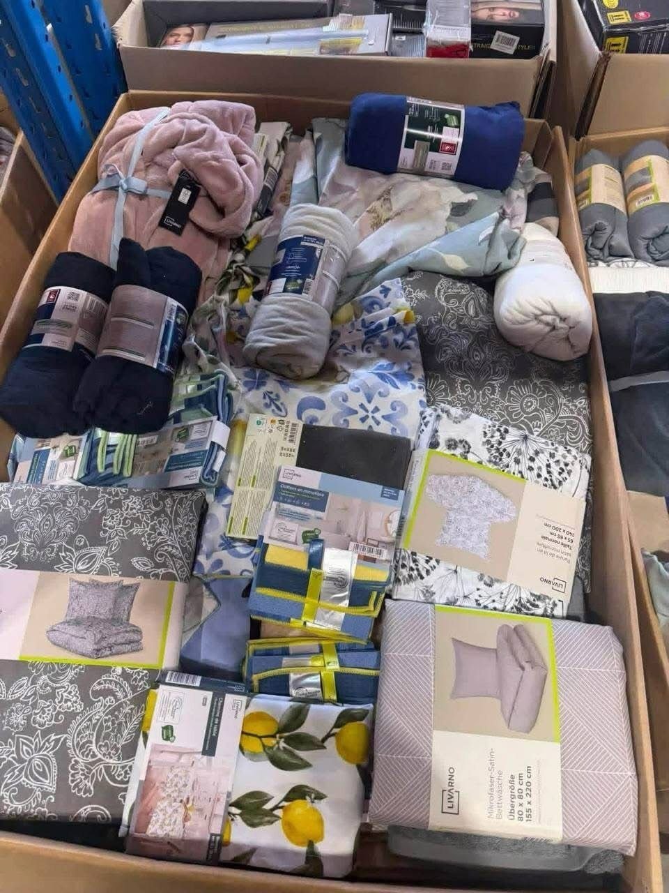 Home textile pallet with assorted blanket rolls bedding sets and throws