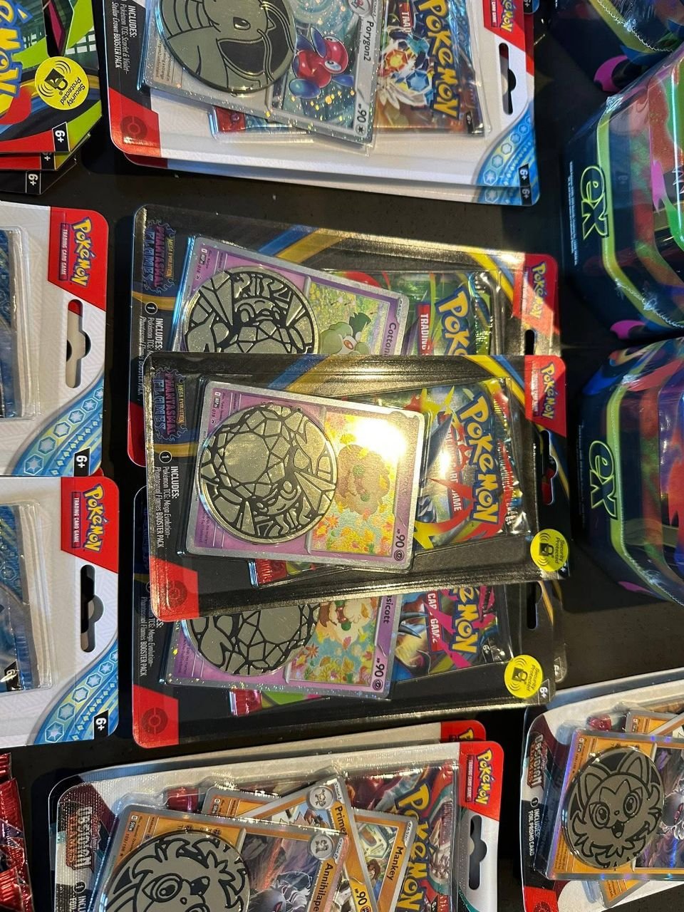 Pokémon TCG trading card booster packs and packaged promo coin card sets