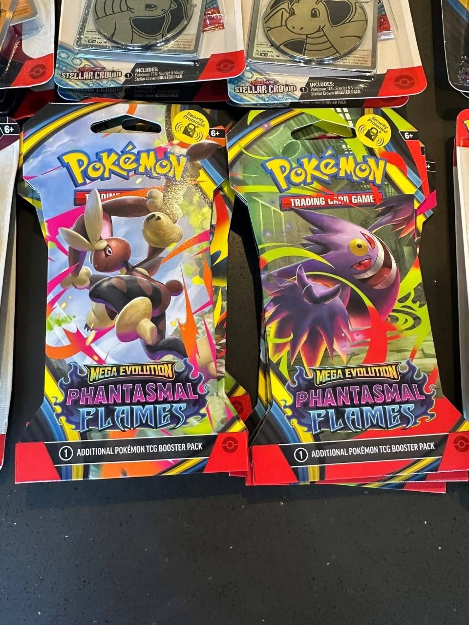 Pokémon TCG Phantasmal Flames blister packs with assorted card artwork