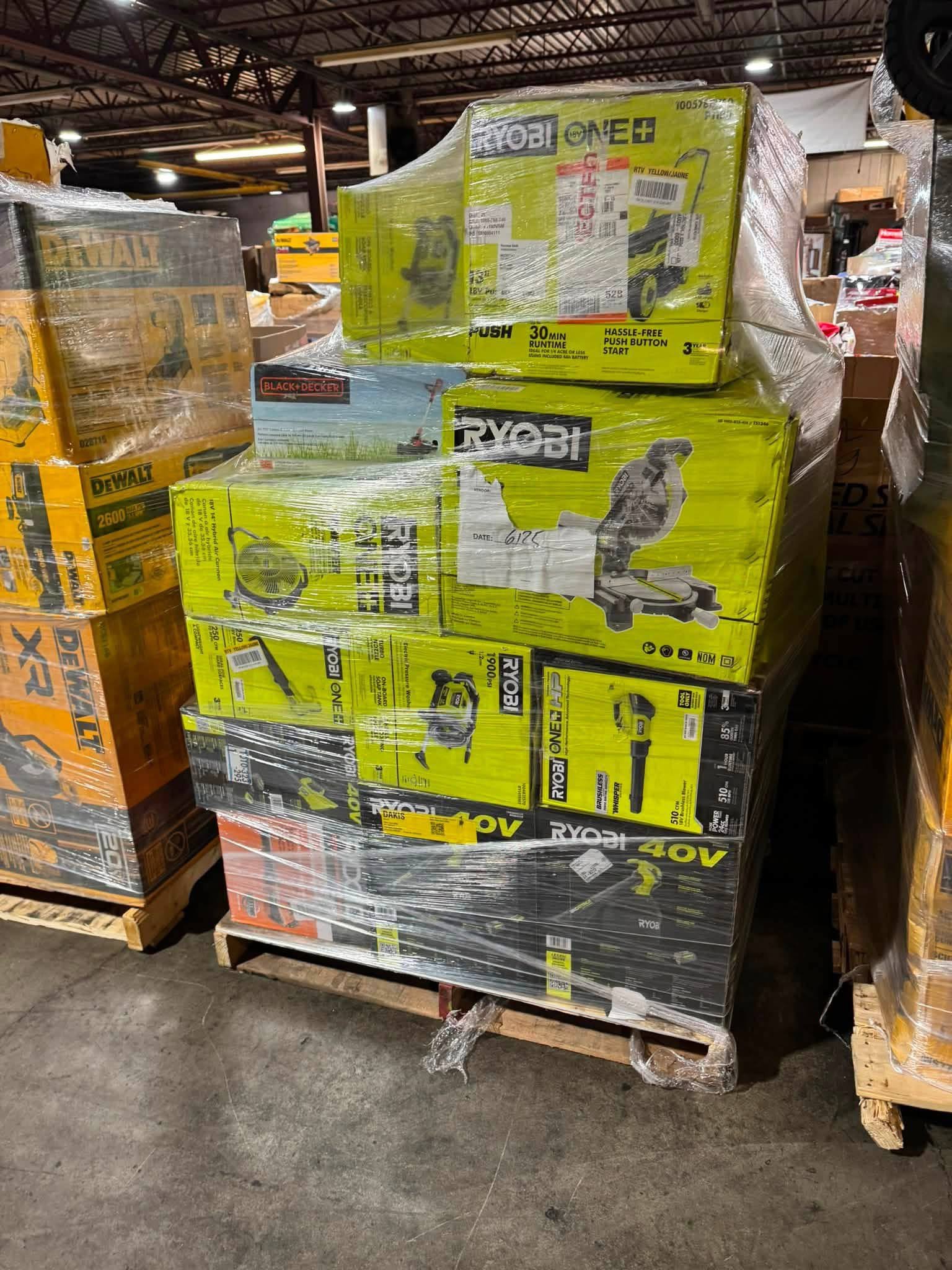 RYOBI power tool pallet with boxed saws blowers and other tools in warehouse