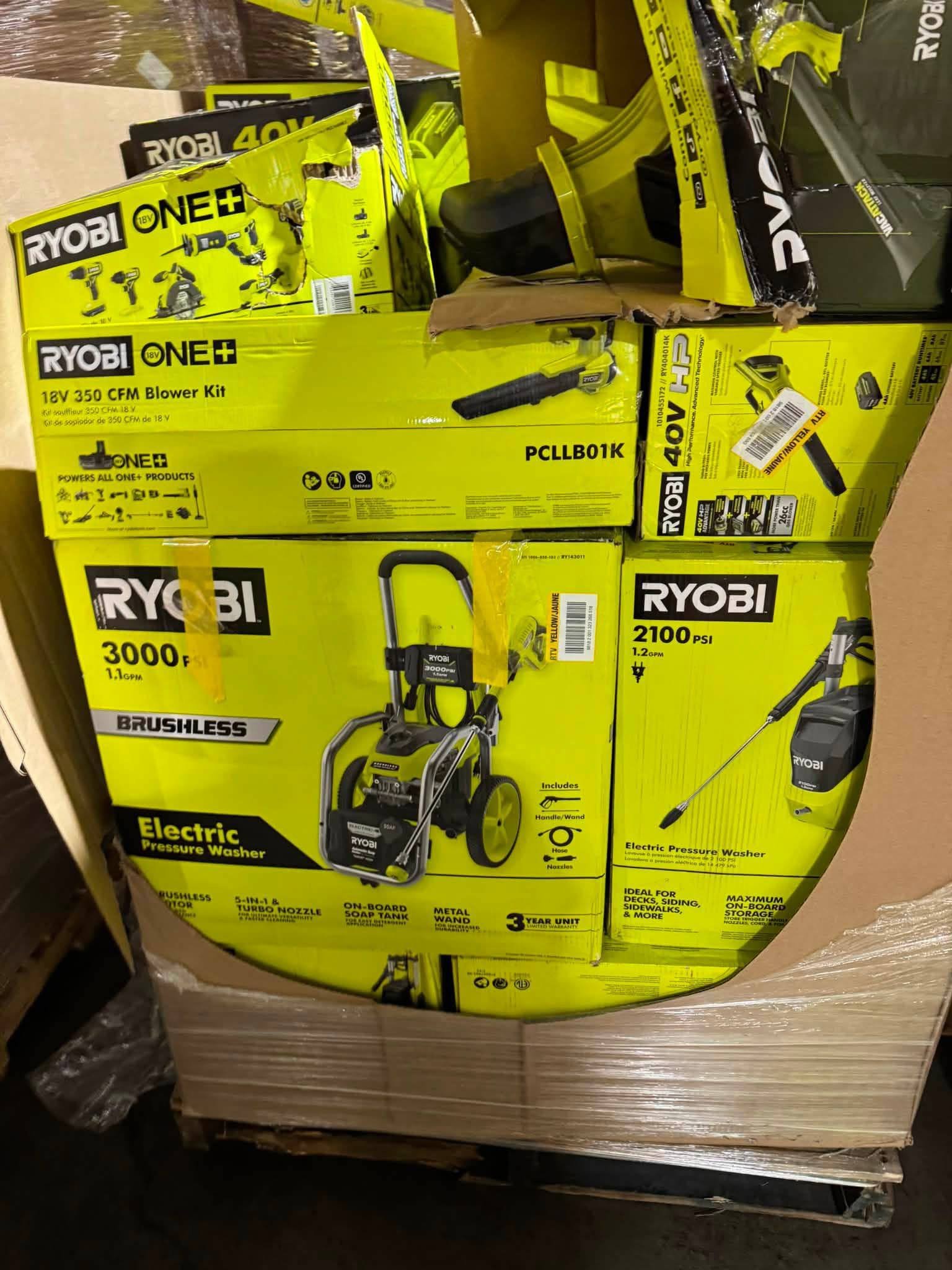 RYOBI tool pallet with pressure washers blower kit and boxes of outdoor power tools
