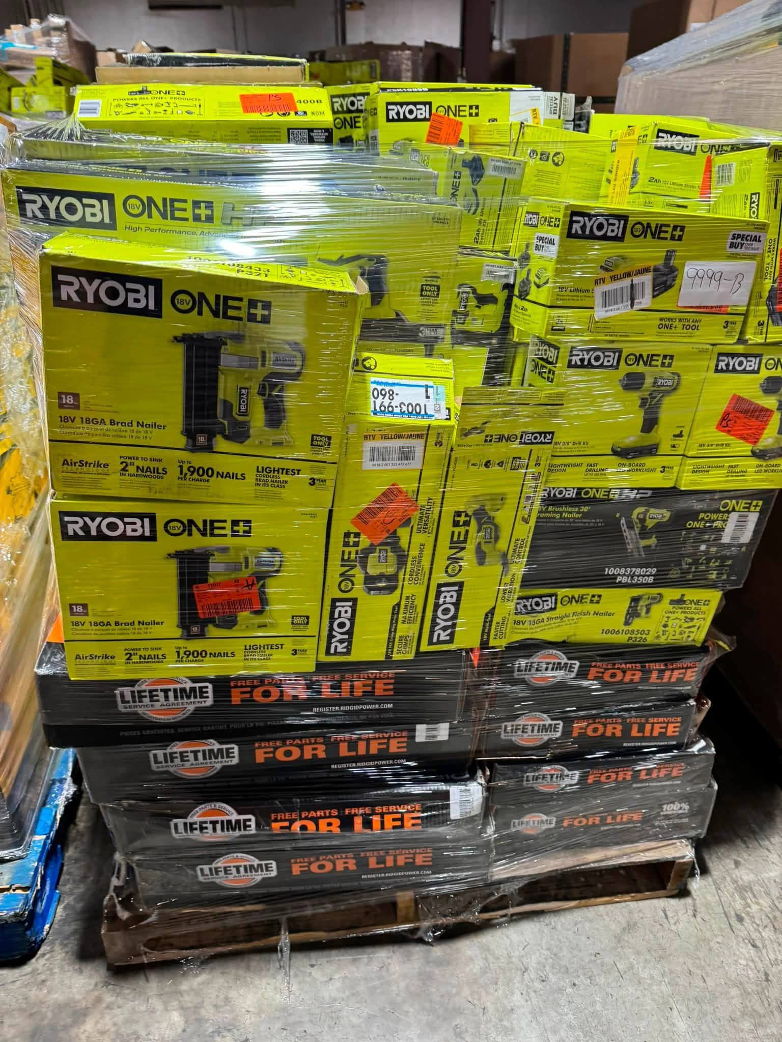 Wrapped RYOBI and RIDGID pallet with drills nailers and orange RIDGID tool boxes